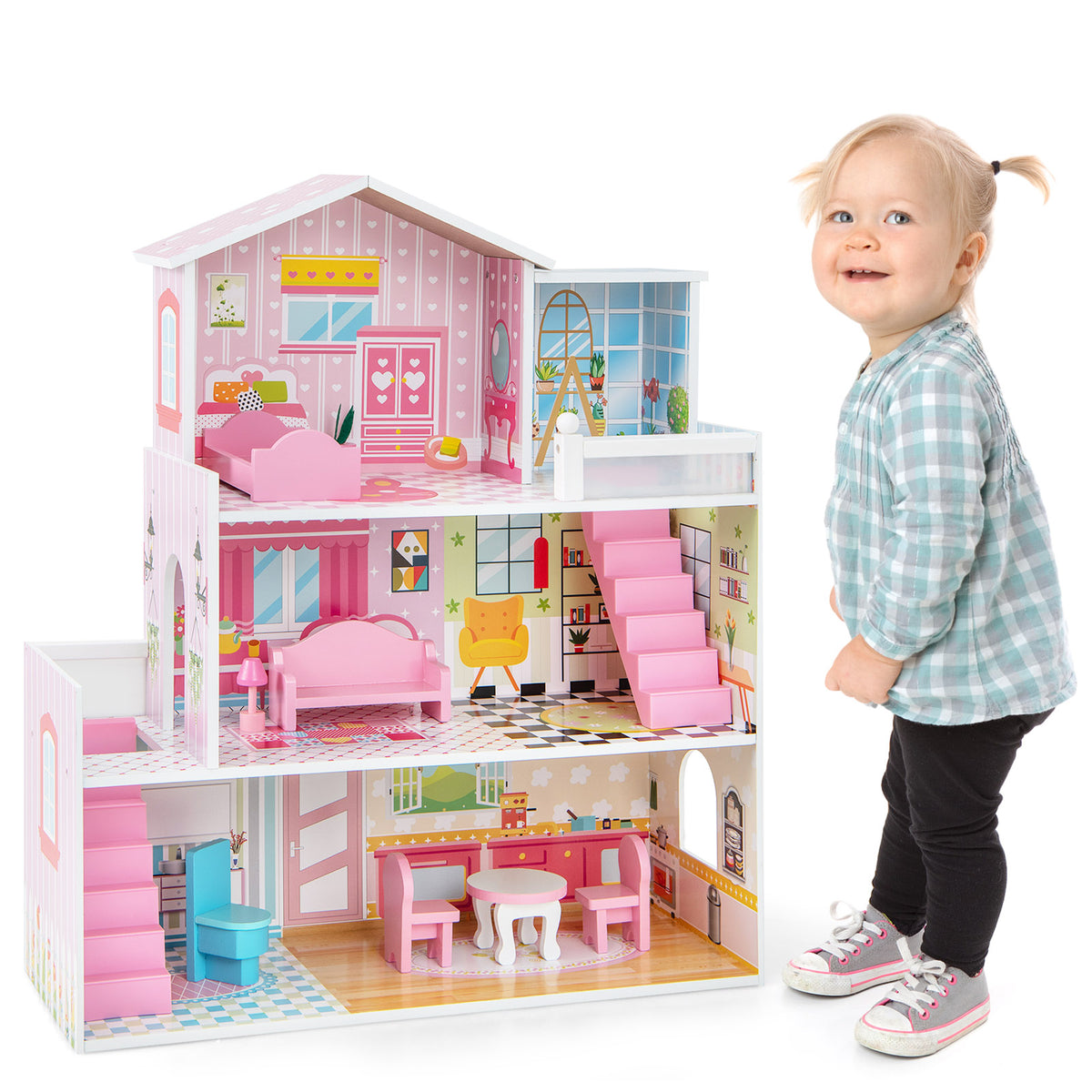 A smiling baby girl standing next to the pink wooden playhouse