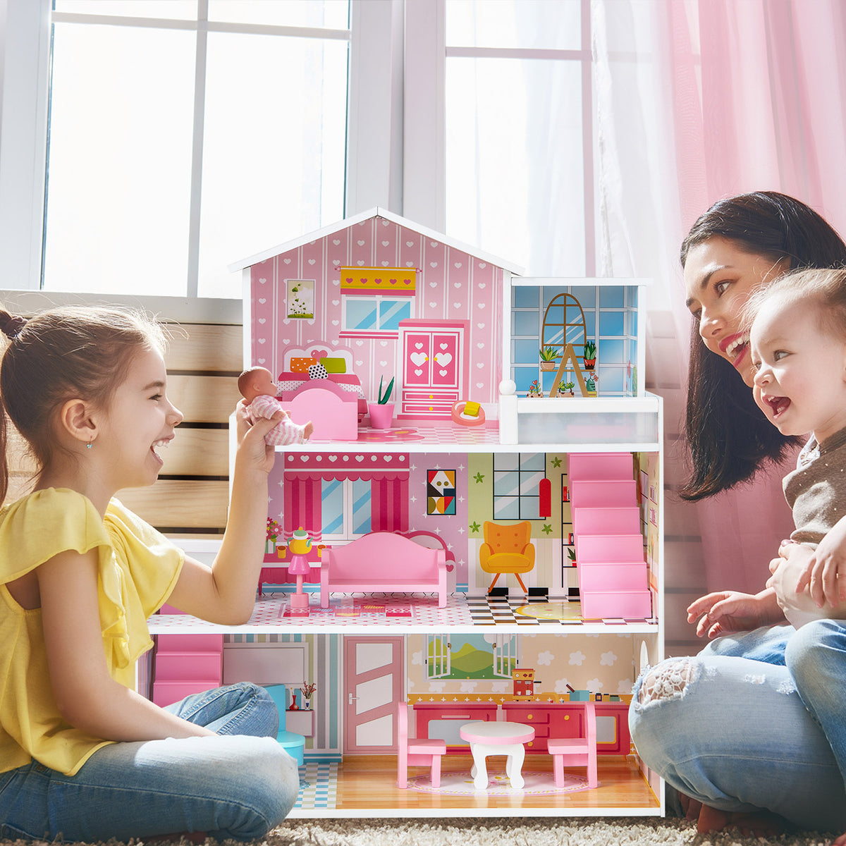 A mother and two children playing with the pink wooden playhouse