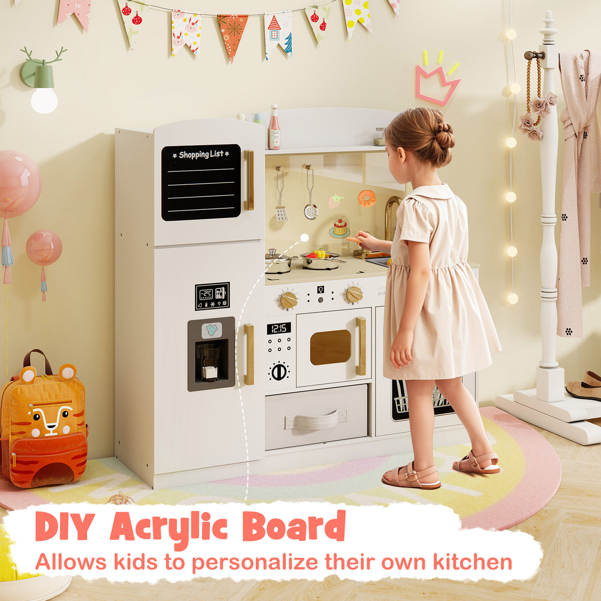 Girl personalising the white wooden kitchen playset with a chalk marker