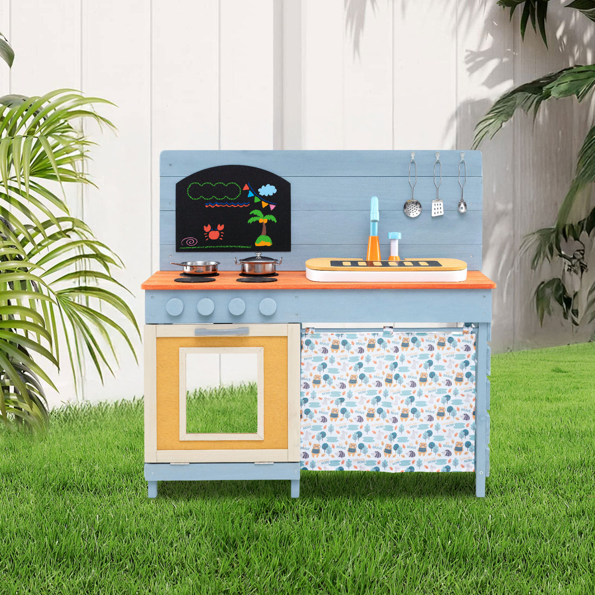 The blue wooden play kitchen set is placed outdoors on a lawn