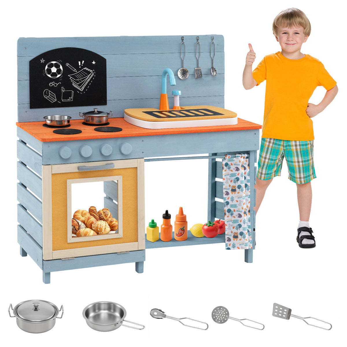 A boy gives a thumbs up next to the blue play kitchen set with accessories