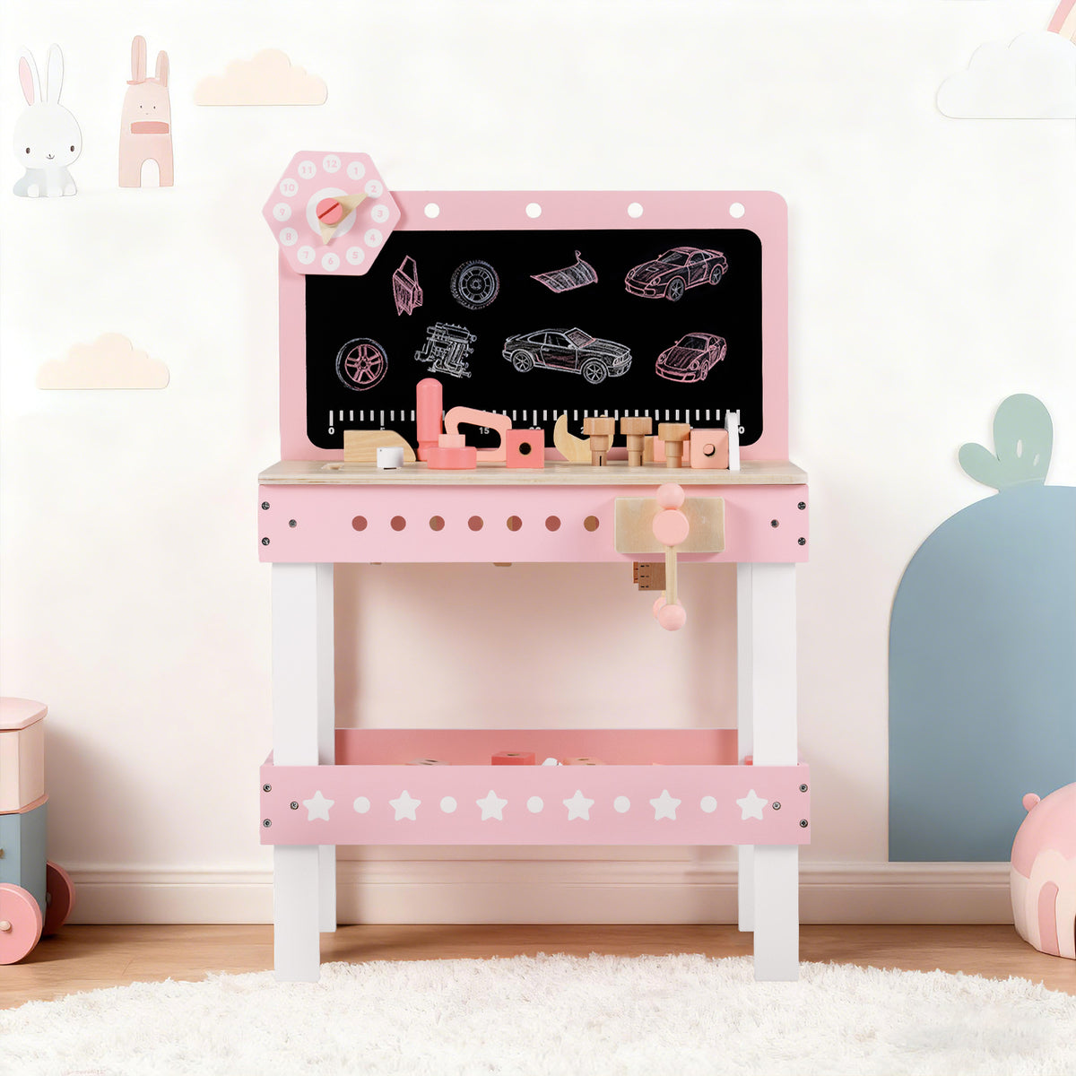 The pink wooden play workbench with blackboard and accessories displayed in a child's room