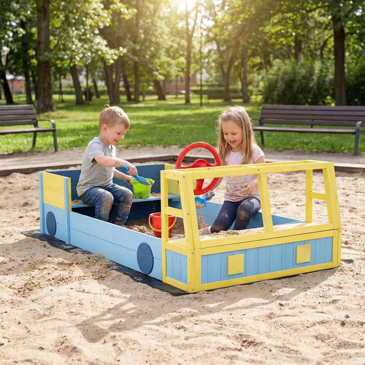 The car sand box placed on a sandy ground in a park with two children playing with toys