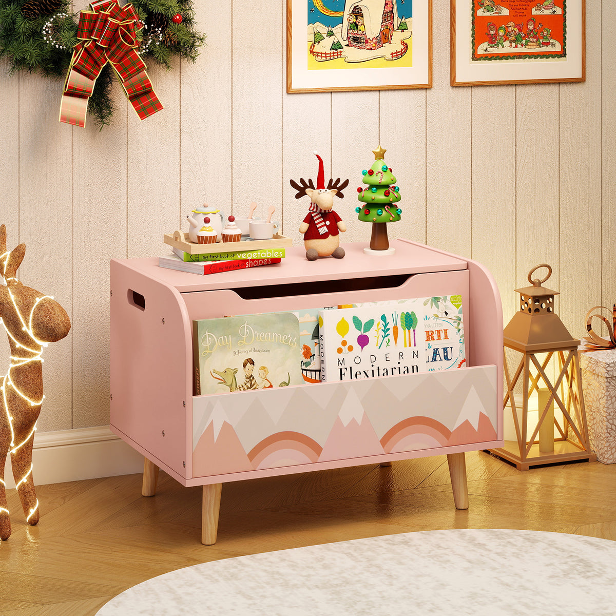 Pink wooden toy box with bookshelf decorated for Christmas in a living room