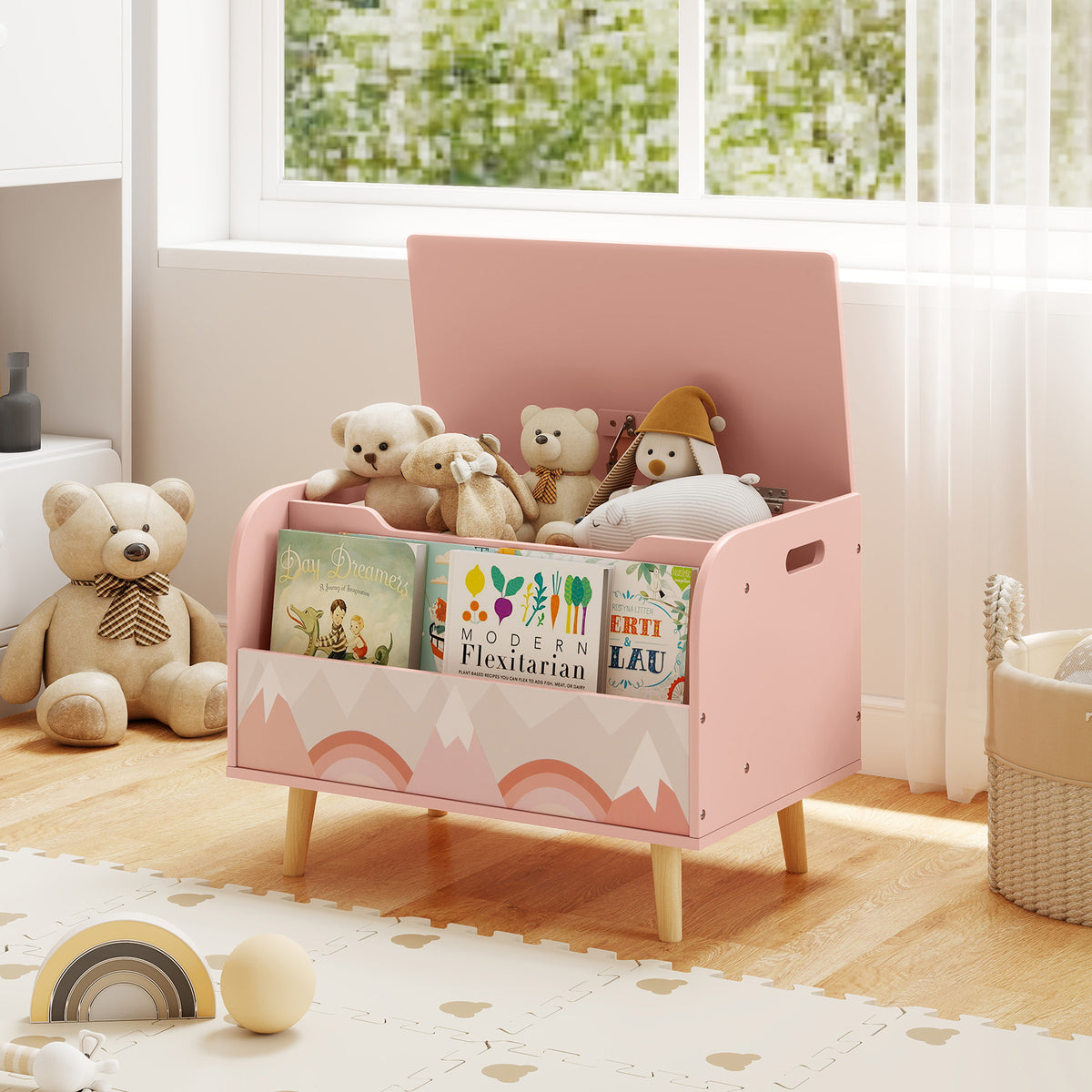 Pink kids toy storage box with bookshelf filled with books and toys in a nursery