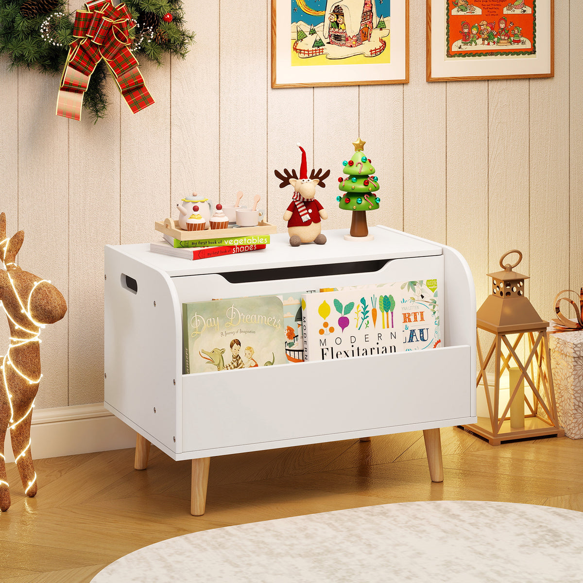 The white toy chest with bookshelf is displayed in a festive room setting