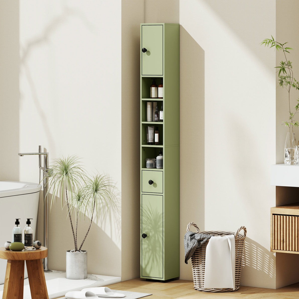 Green slim bathroom cabinet with a drawer and shelves in a modern bathroom setting