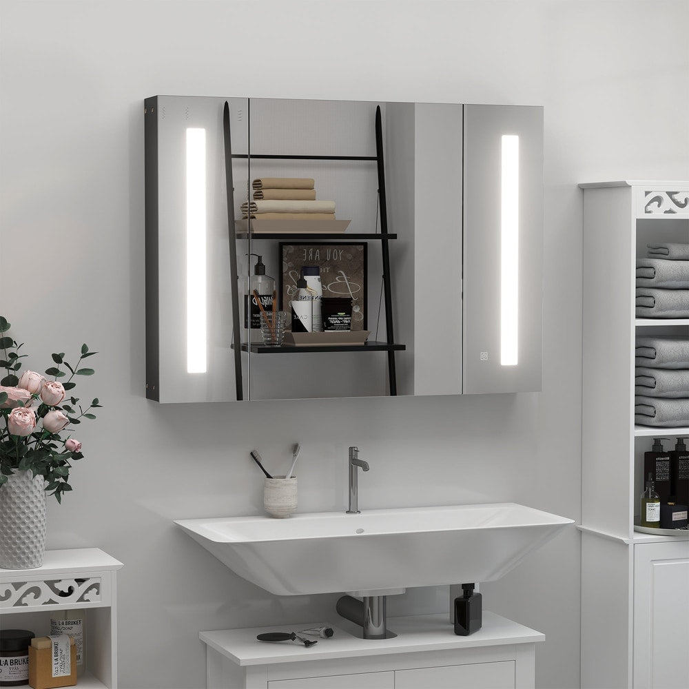 The bathroom mirror cabinet is installed above a sink in a modern bathroom, with toiletries visible inside
