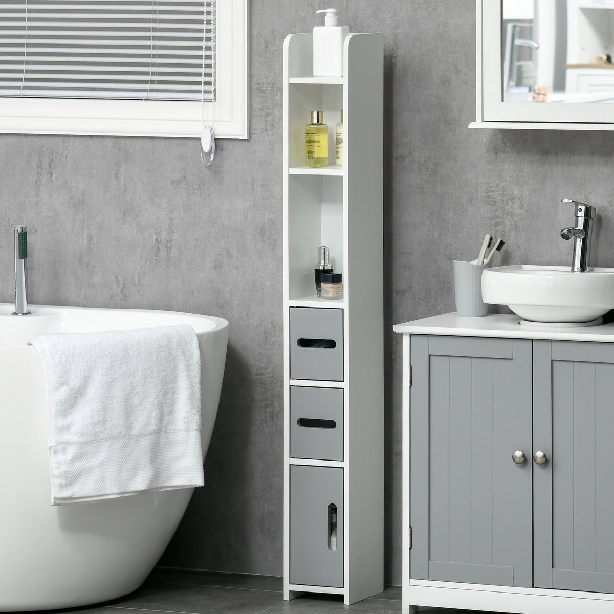 The modern bathroom storage cabinet in a grey tiled bathroom next to a bathtub and a vanity unit