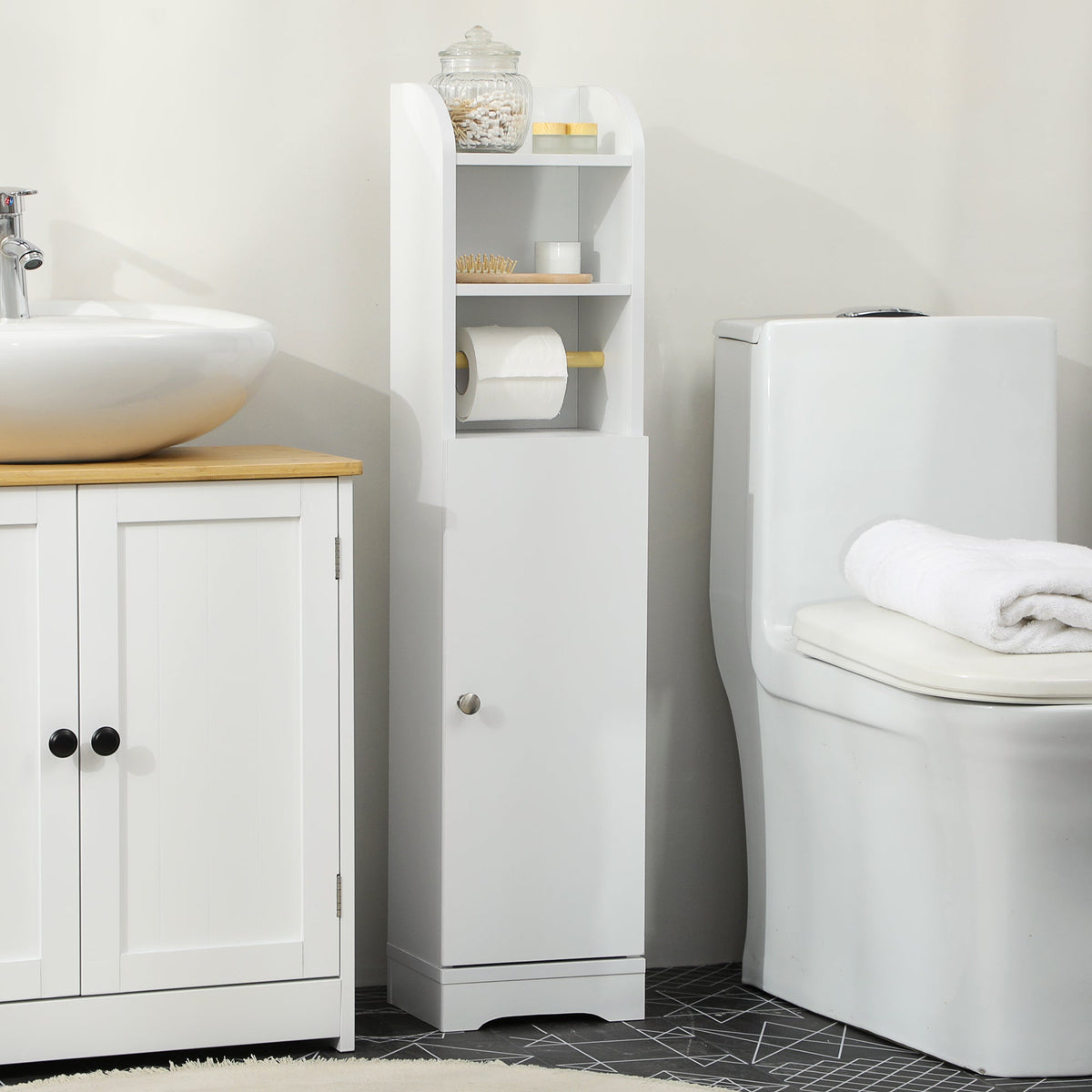 The white narrow bathroom cabinet shown next to a sink and toilet in a bathroom setting