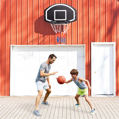 Father and son playing basketball with the wall mounted set outdoors