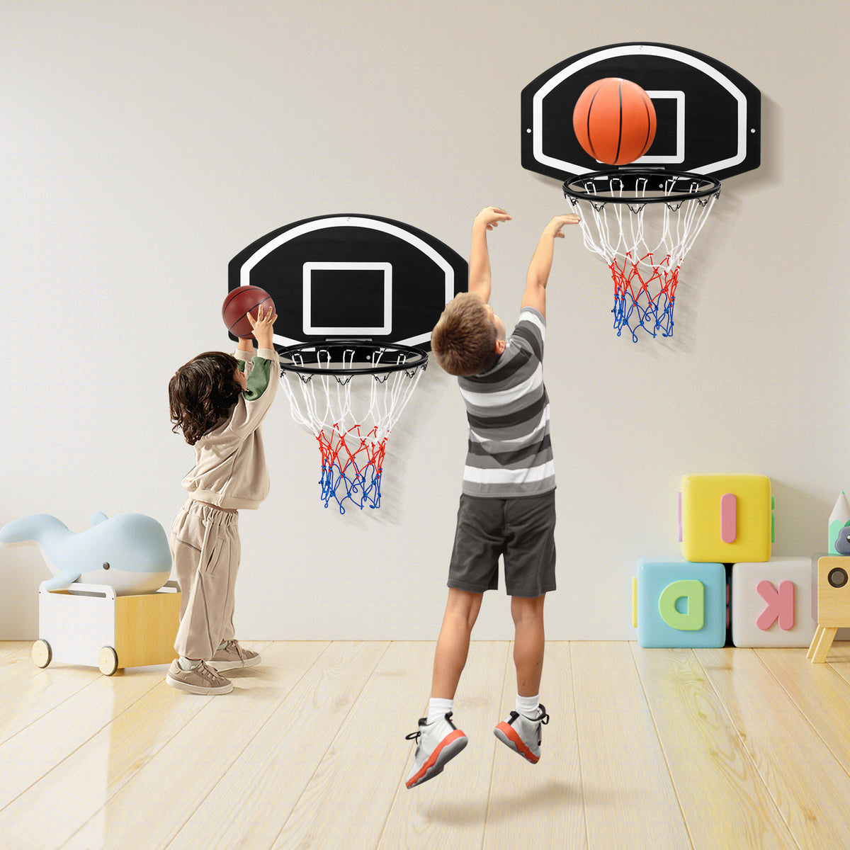 Children playing with the indoor wall mounted basketball set in a bright room
