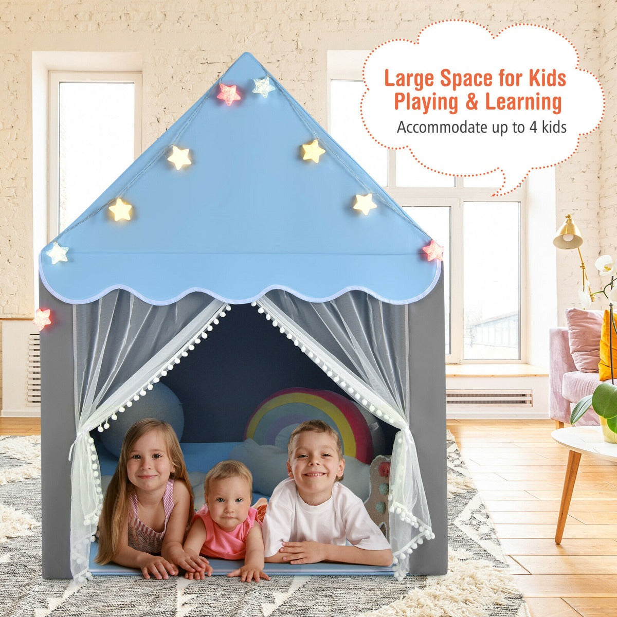 Three young children smiling inside the spacious blue and grey play tent