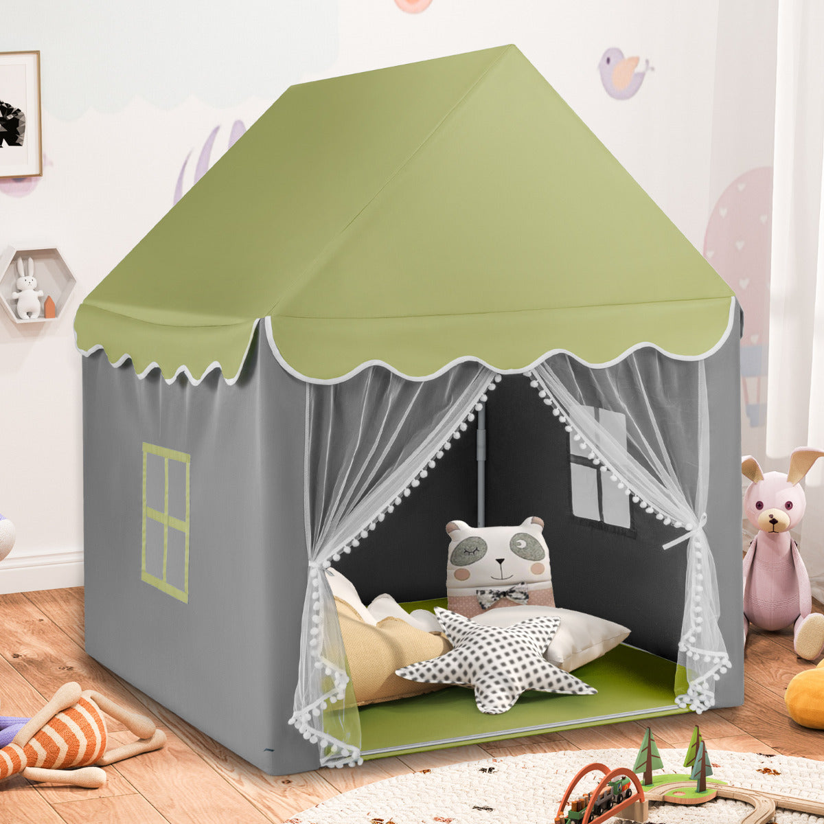 The play tent is grey with a light green roof and white pompom trim