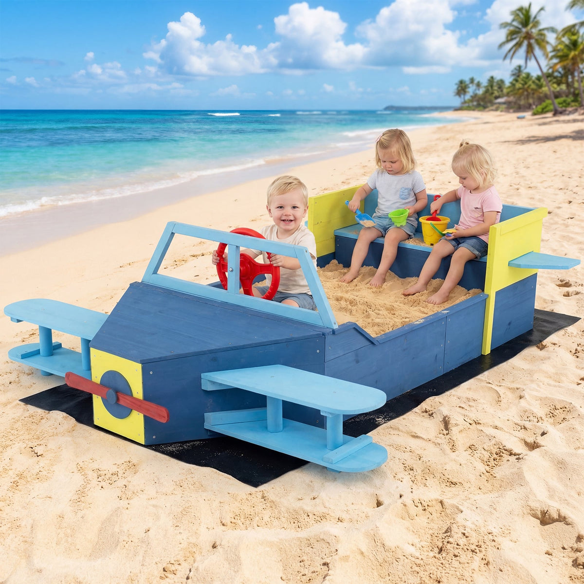 Children playing in the large wooden kids sandbox with bottom liner and bench seat on a beach