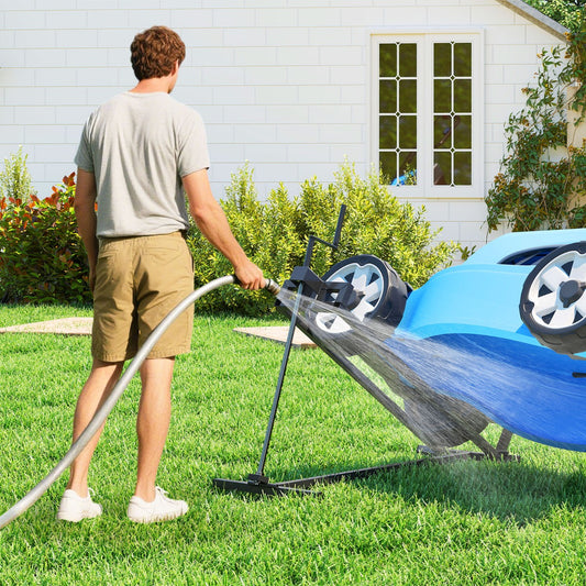 The garden tool holding a blue mower while a man cleans the underside with a water hose