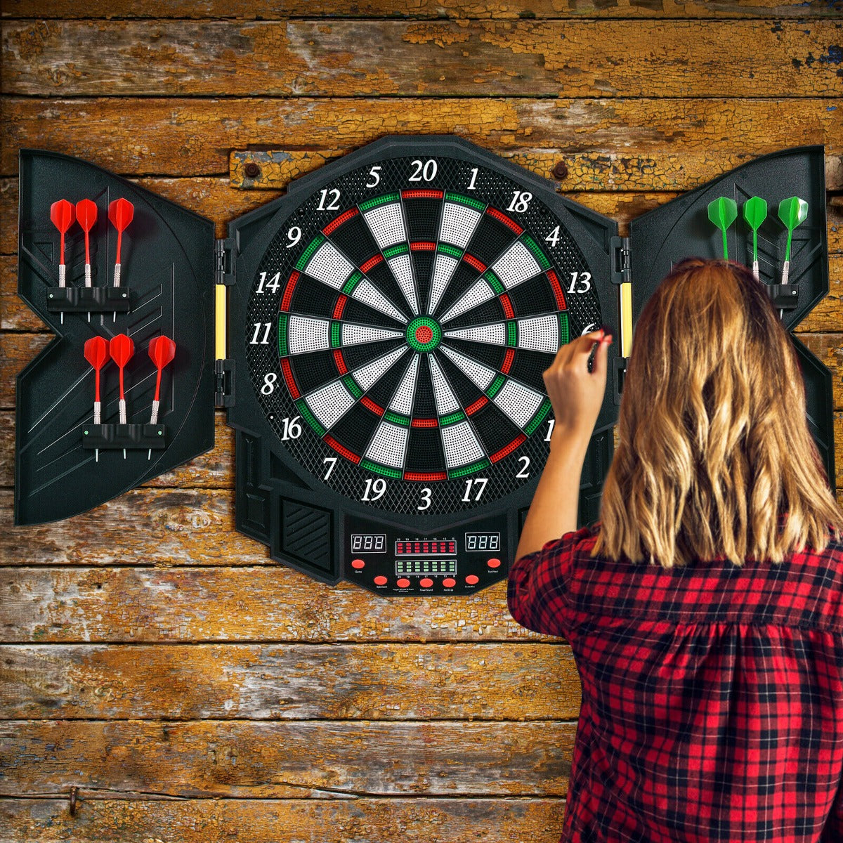 The game room board mounted on a wooden wall with a person throwing a dart at the target