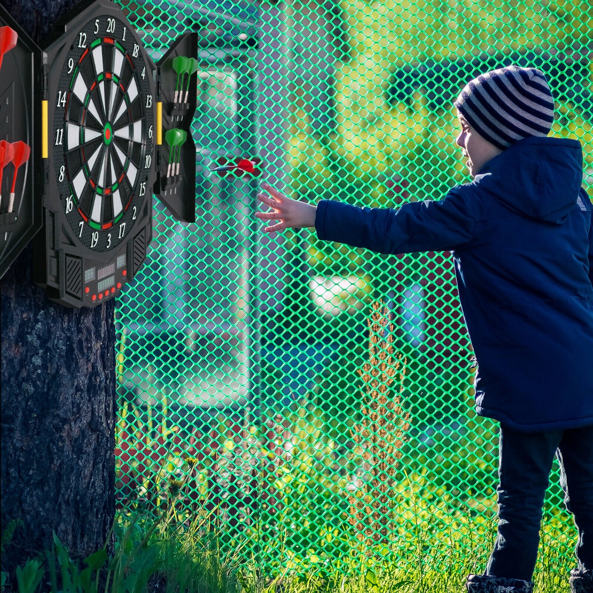 The game room board attached to a tree with a child throwing a dart towards the target