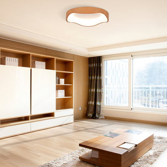 The ceiling light installed in a bright living room with wooden furniture and large windows