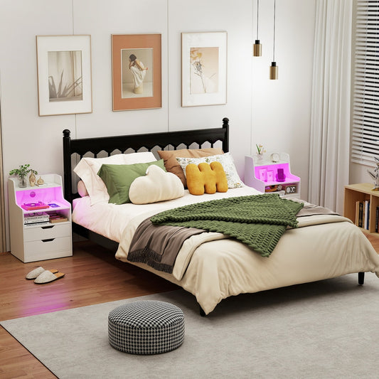 The white bedside table with charging station and LED lights in a bedroom setting next to a bed
