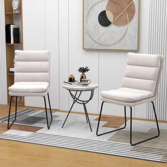 Two white upholstered accent chairs in a minimalist room setting
