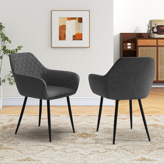 The dining chairs shown from the front and back in a bright living room with a patterned rug