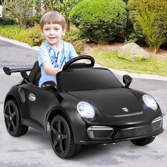 Black kids electric car with a child driving it outside on a paved area