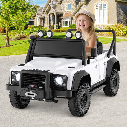 Licensed Land Rover Defender 12V Ride On Toy Car, the kids electric car parked on a driveway in front of a house with a child
