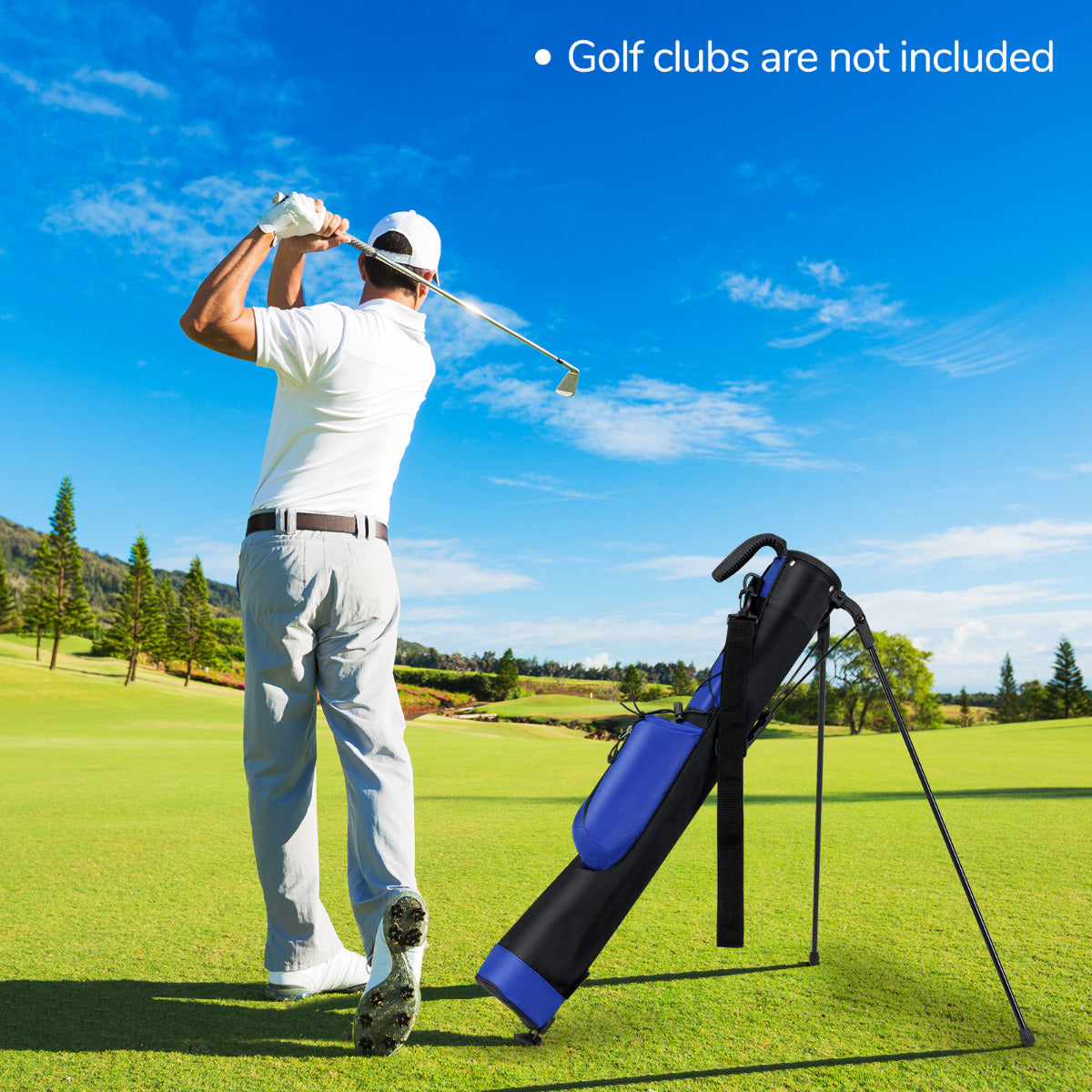 Man playing golf with a blue and black golf bag standing nearby