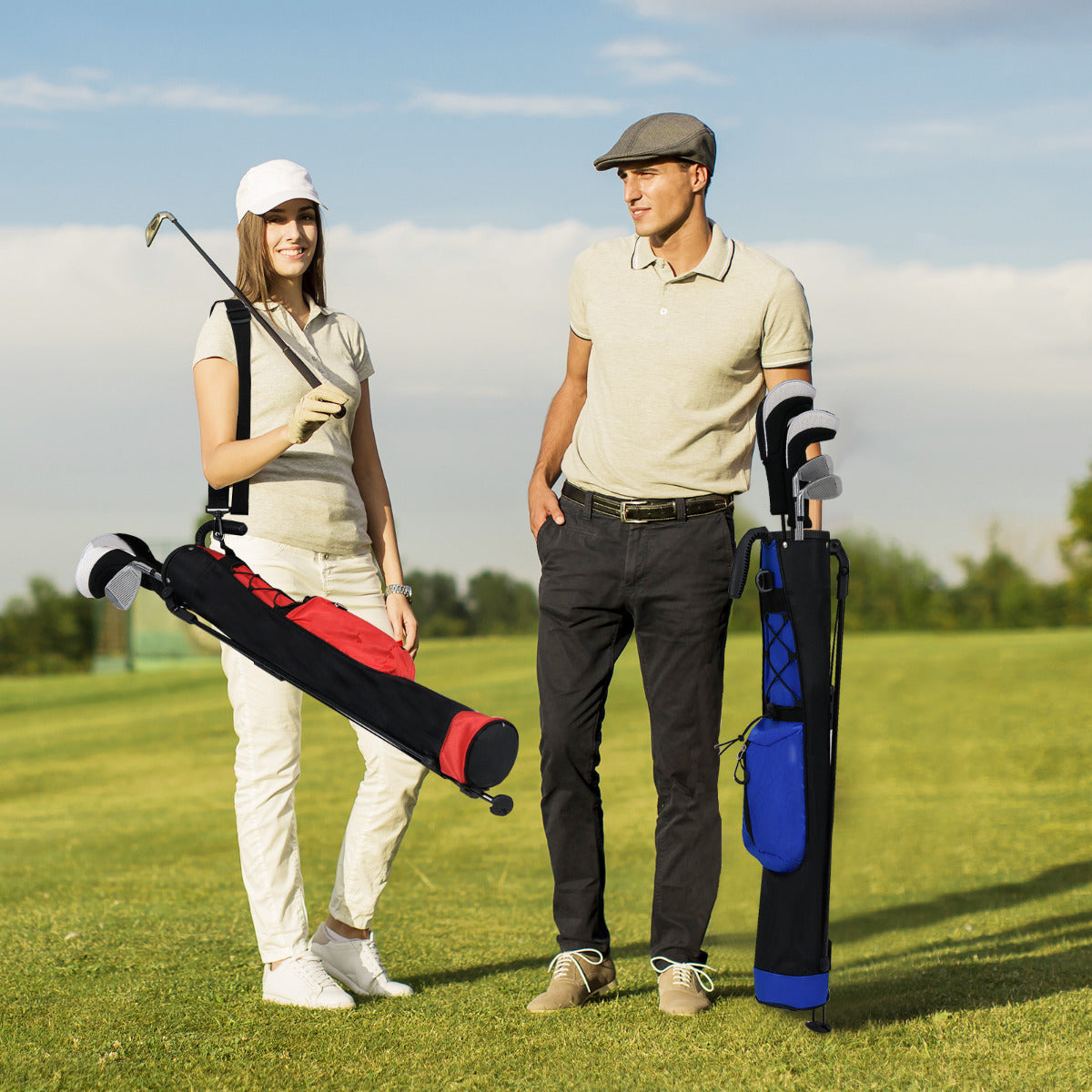 Two people on a golf course with golf bags, one blue and one red