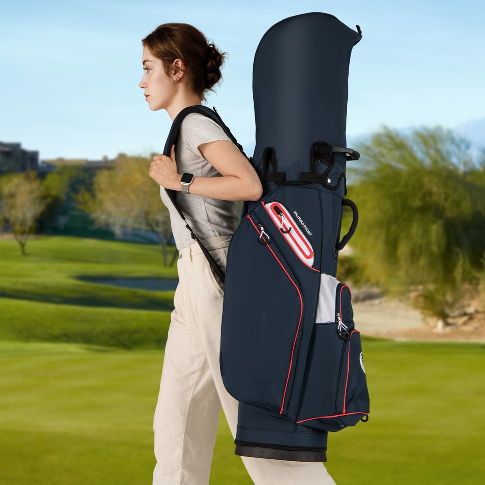 Woman carrying the navy golf cart bag over her shoulder on a golf course