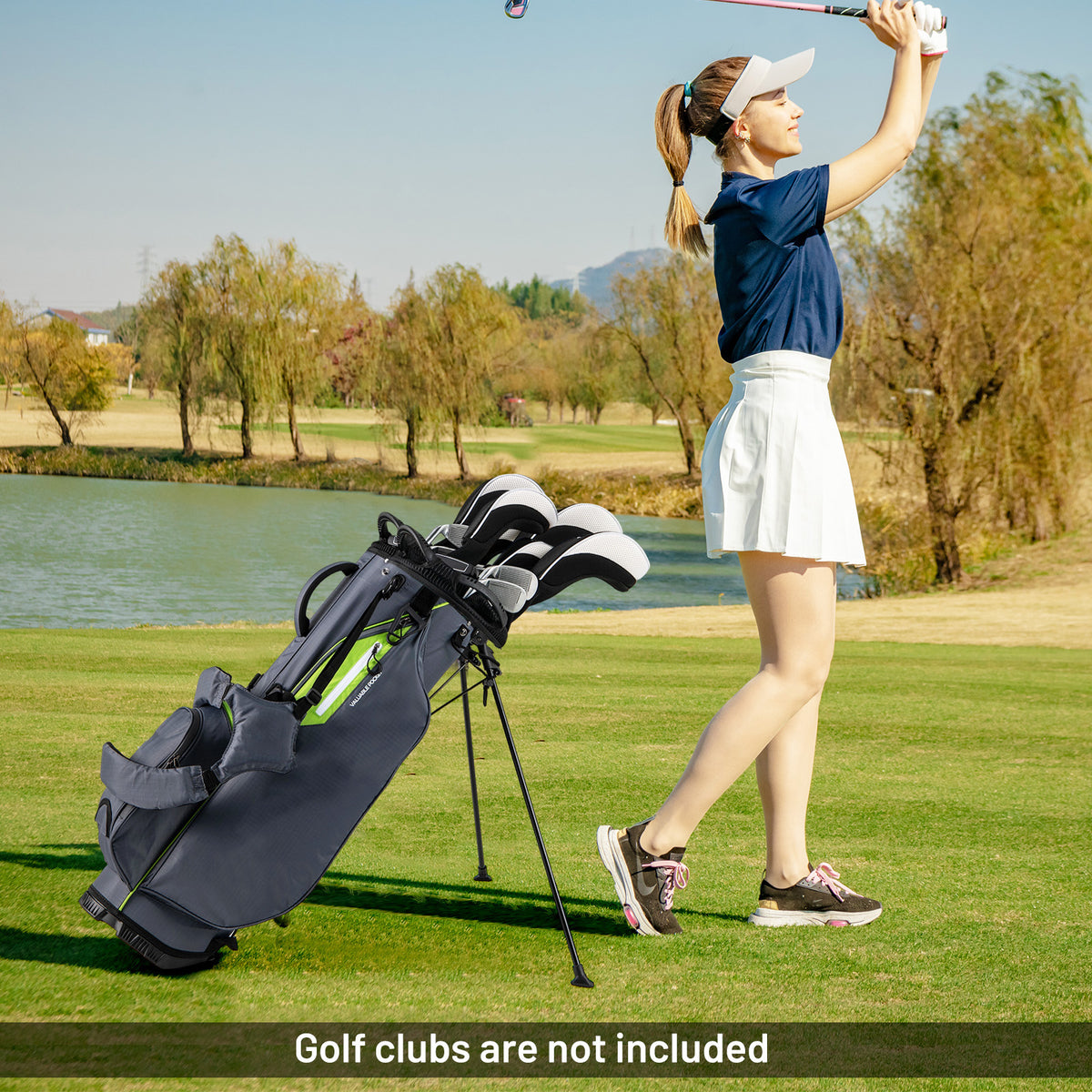 The golf stand bag in use on a golf course with a woman playing golf, showing the top dividers