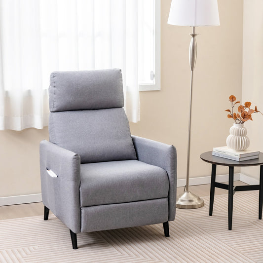 The grey fabric recliner armchair is shown in a room with a lamp and side table