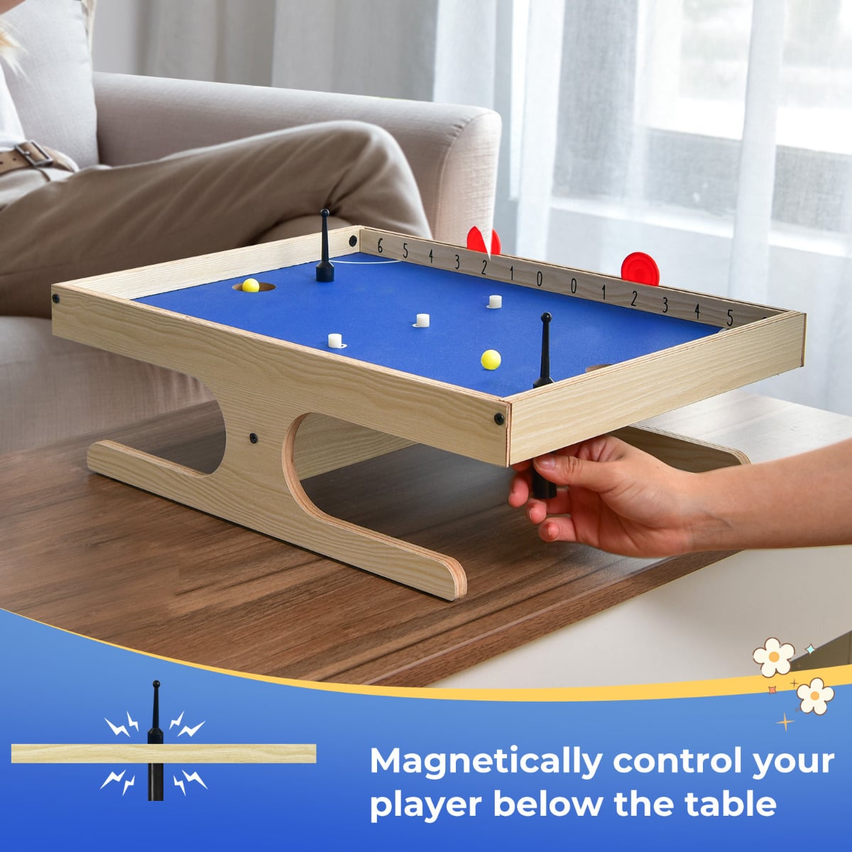 Close up of the Magnetic Mini Foosball Table with a hand controlling a player