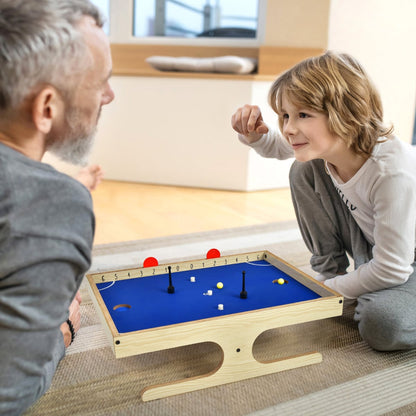 Father and son playing with the Magnetic Mini Foosball Table on the floor