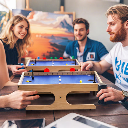 Group of friends playing the Magnetic Mini Foosball Table at a table