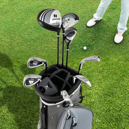 The golf clubs arranged inside the grey carry bag standing on a green grass golf course