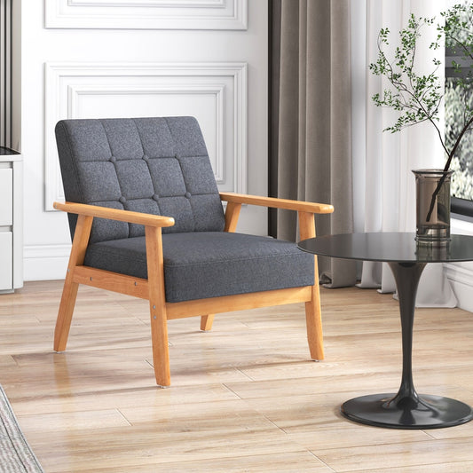 Grey fabric accent chair with wooden arms and legs in a living room setting
