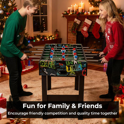 Two people playing the game room table in a festive living room setting near a fireplace