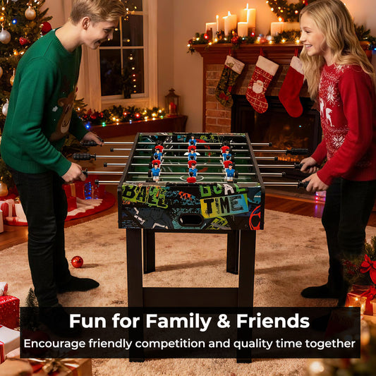 Two people playing the game room table in a festive living room setting near a fireplace