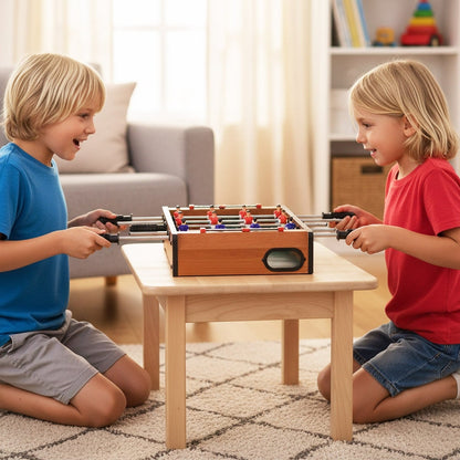 Two children playing with the game room table on a small wooden coffee table