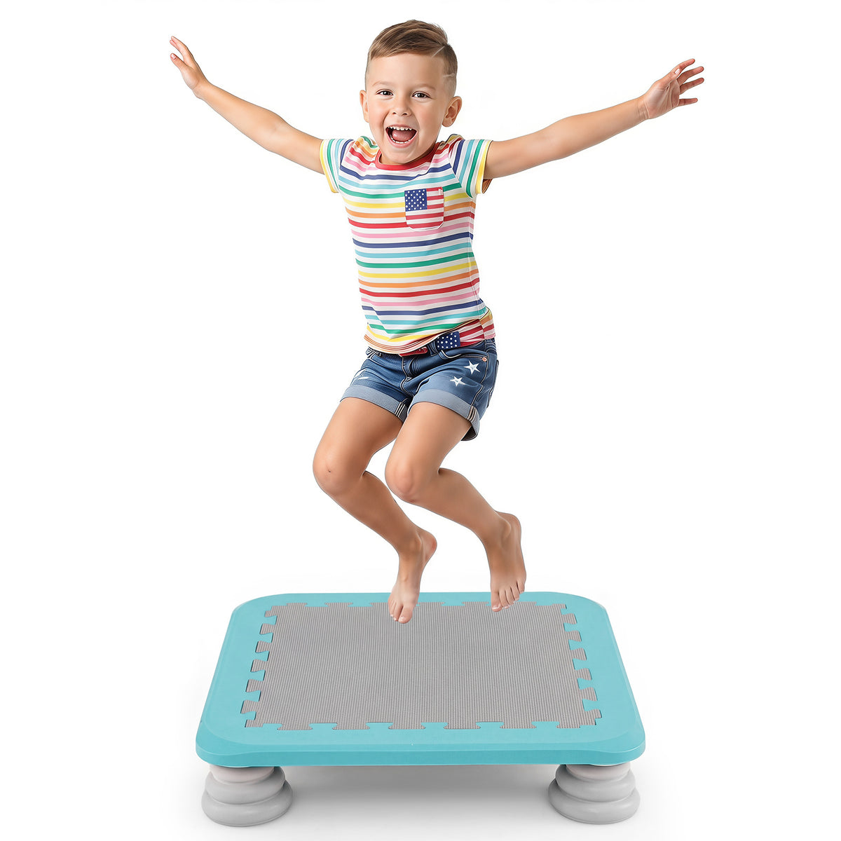 A young boy in colourful shorts jumps high on the blue square trampoline against a white background