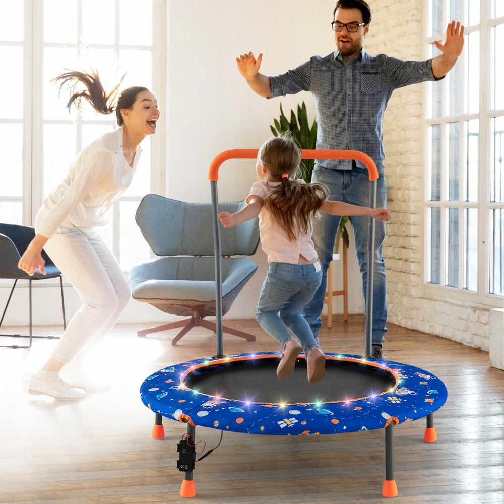 The blue kids trampoline with a family jumping on it indoors