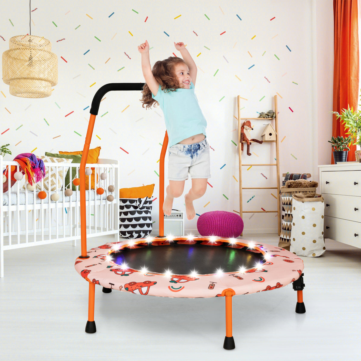 The children trampoline placed in a colourful nursery with a child jumping on the mat