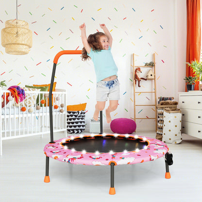 A child bouncing on a pink kids trampoline with LED lights in a nursery room