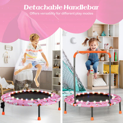Two children using the pink kids trampoline with LED lights and detachable handlebar