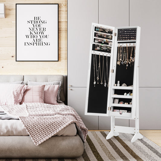 White jewellery cabinet with mirror in a bedroom setting next to a bed