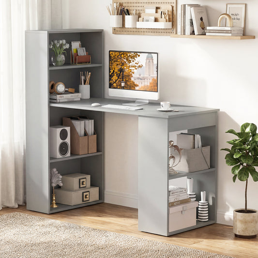 The office desk placed in a bright home study with a computer and various decorative items