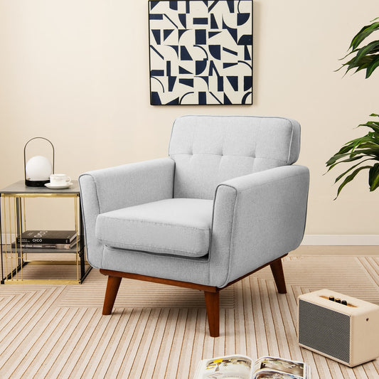 Grey accent chair in a stylish living room setting with a side table and speaker