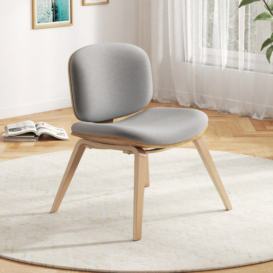 The accent chair placed on a round rug in a bright living room setting